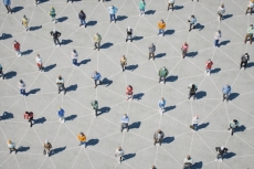 A group of people distancing themselves with a pattern of lines underneath them